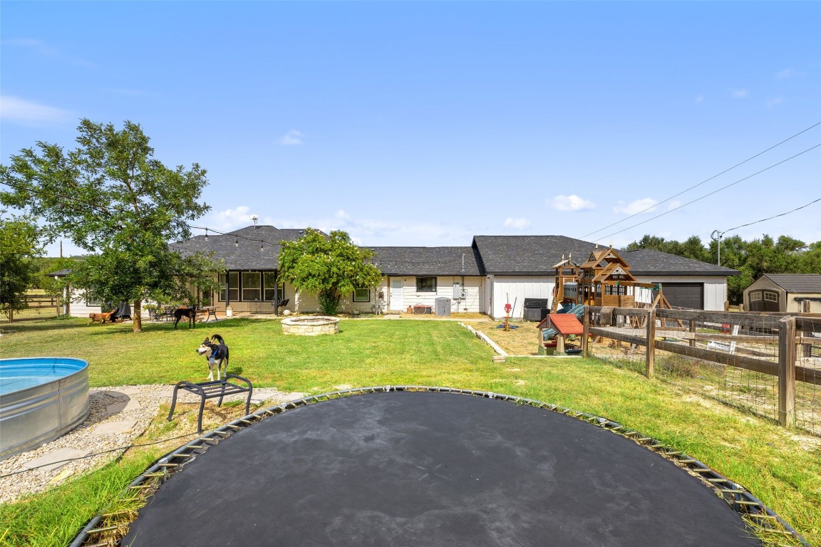 213 Beauchamp Road Dripping Springs, TX 78620 - Photo 33 of 40 a view of a swimming pool and lounge chairs