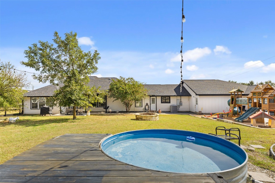 213 Beauchamp Road Dripping Springs, TX 78620 - Photo 34 of 40 a swimming pool with outdoor seating and yard