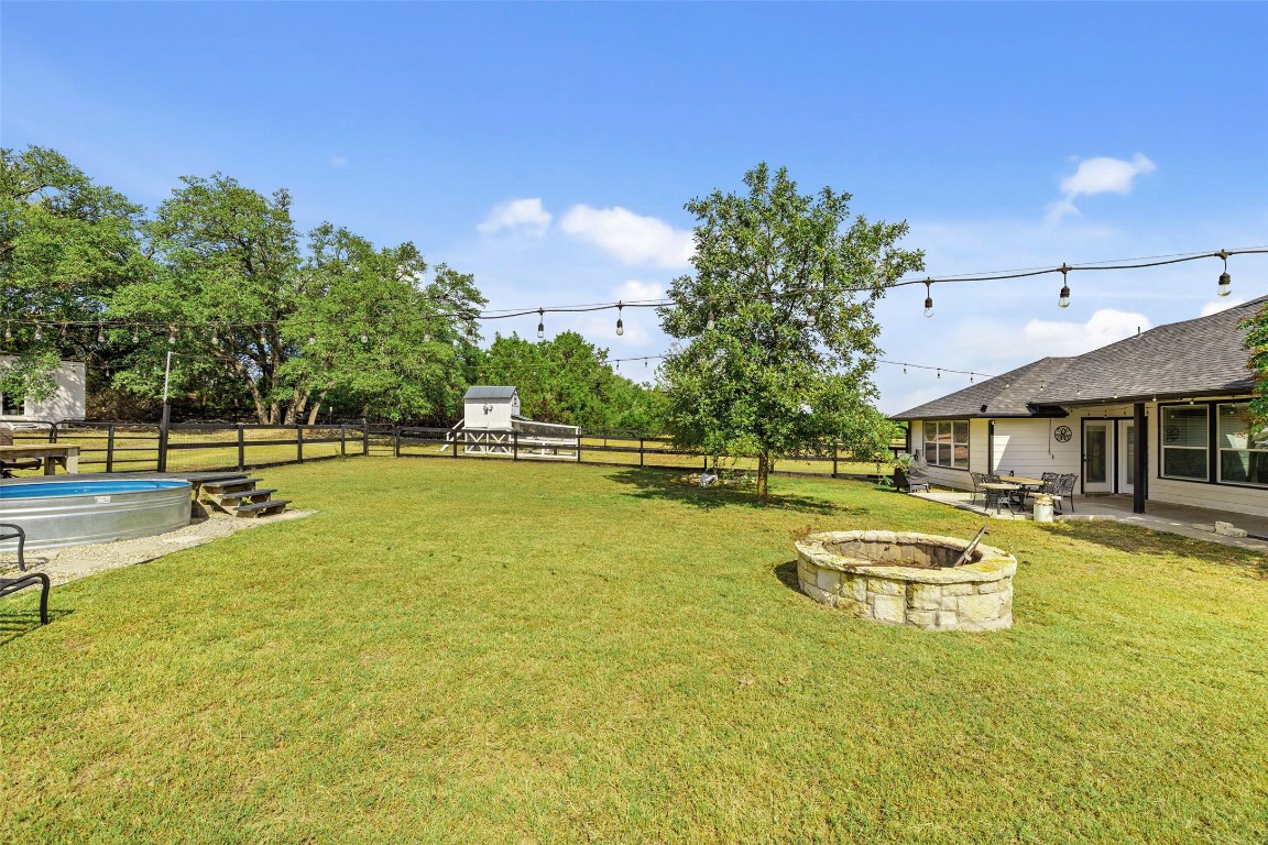 213 Beauchamp Road Dripping Springs, TX 78620 - Photo 36 of 40 a view of a swimming pool with lawn chairs and plants