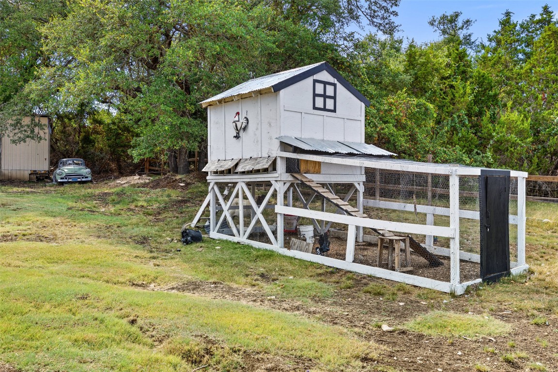 213 Beauchamp Road Dripping Springs, TX 78620 - Photo 37 of 40 a view of a house with a yard and sitting area