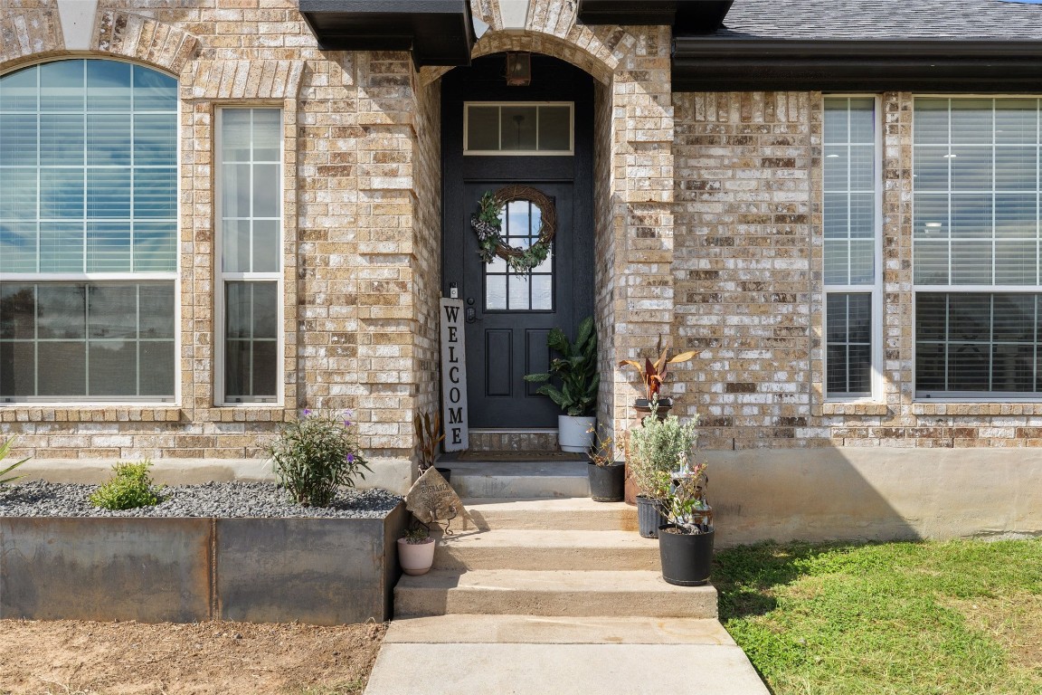 213 Beauchamp Road Dripping Springs, TX 78620 - Photo 5 of 40 a front view of a house with a yard
