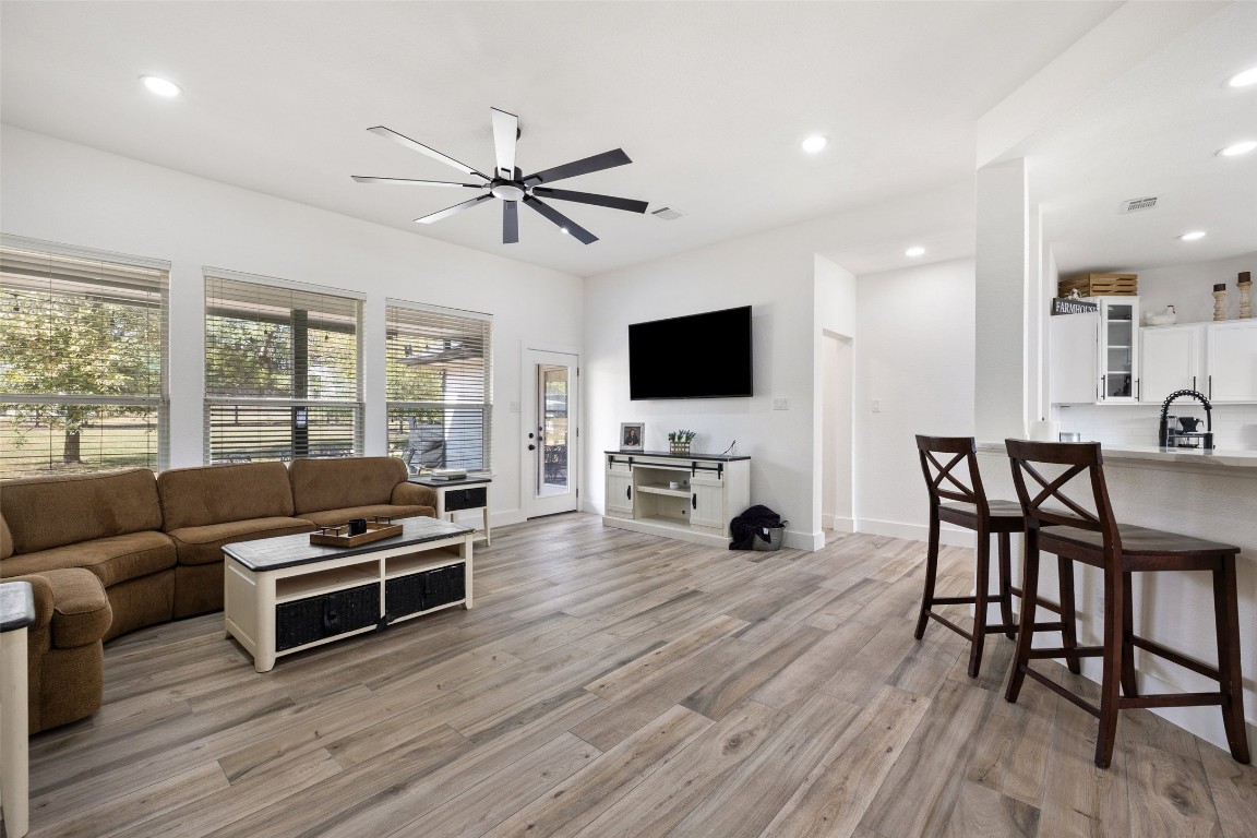 213 Beauchamp Road Dripping Springs, TX 78620 - Photo 6 of 40 a living room with furniture a fireplace and a flat screen tv