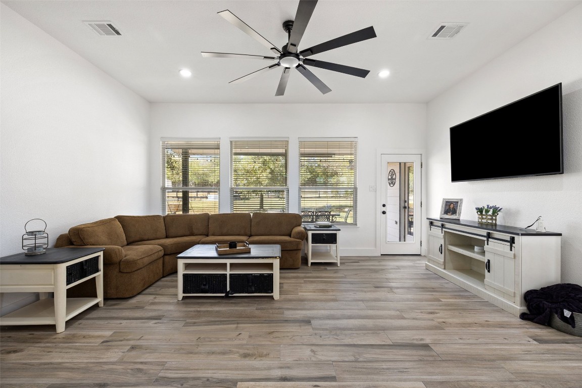 213 Beauchamp Road Dripping Springs, TX 78620 - Photo 7 of 40 a living room with furniture and a flat screen tv
