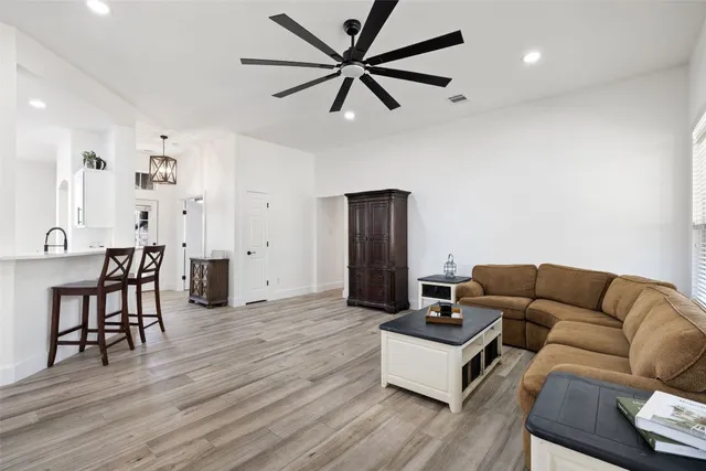 a living room with furniture and a wooden floor