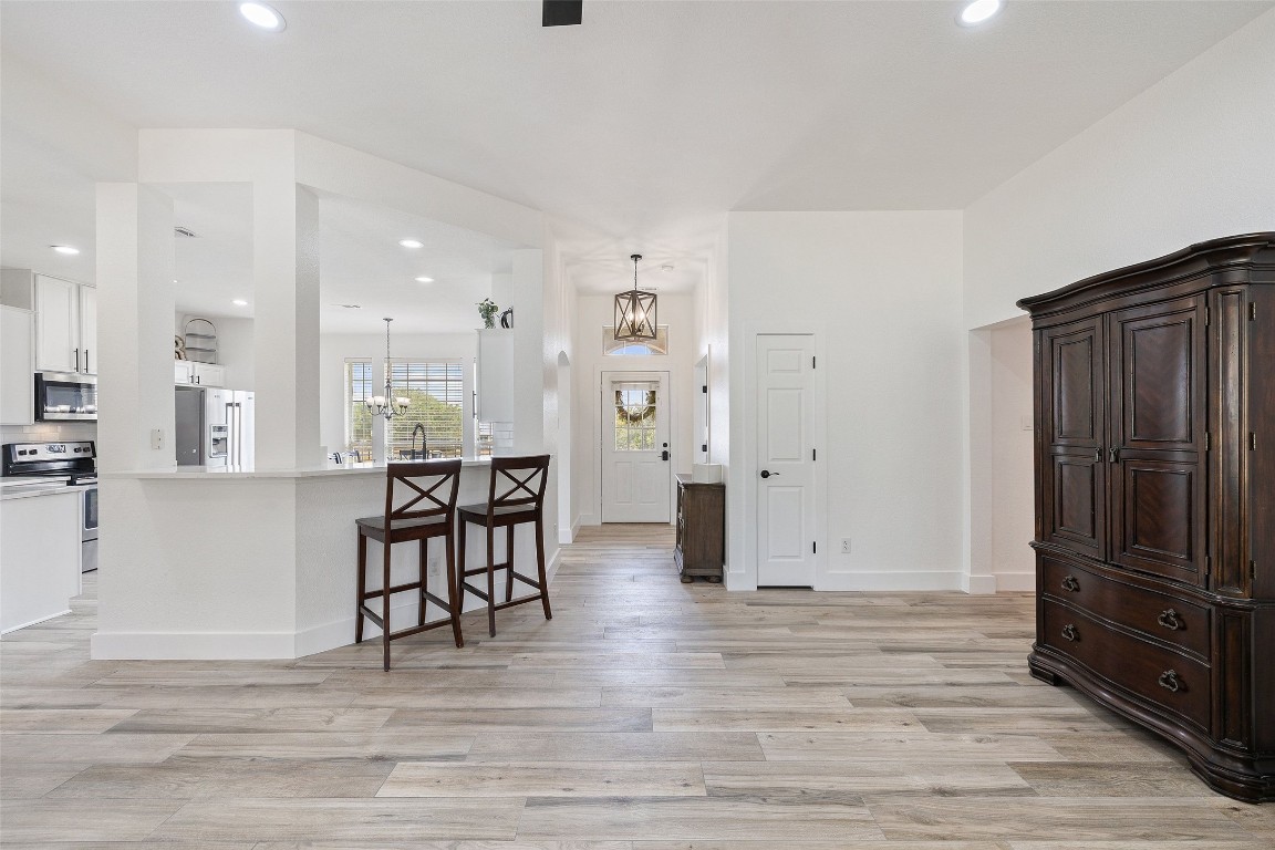 213 Beauchamp Road Dripping Springs, TX 78620 - Photo 10 of 40 an empty room with wooden floor and windows