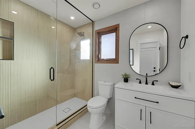 a bathroom with a toilet sink and shower