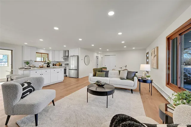 a living room with furniture kitchen view and a dining table