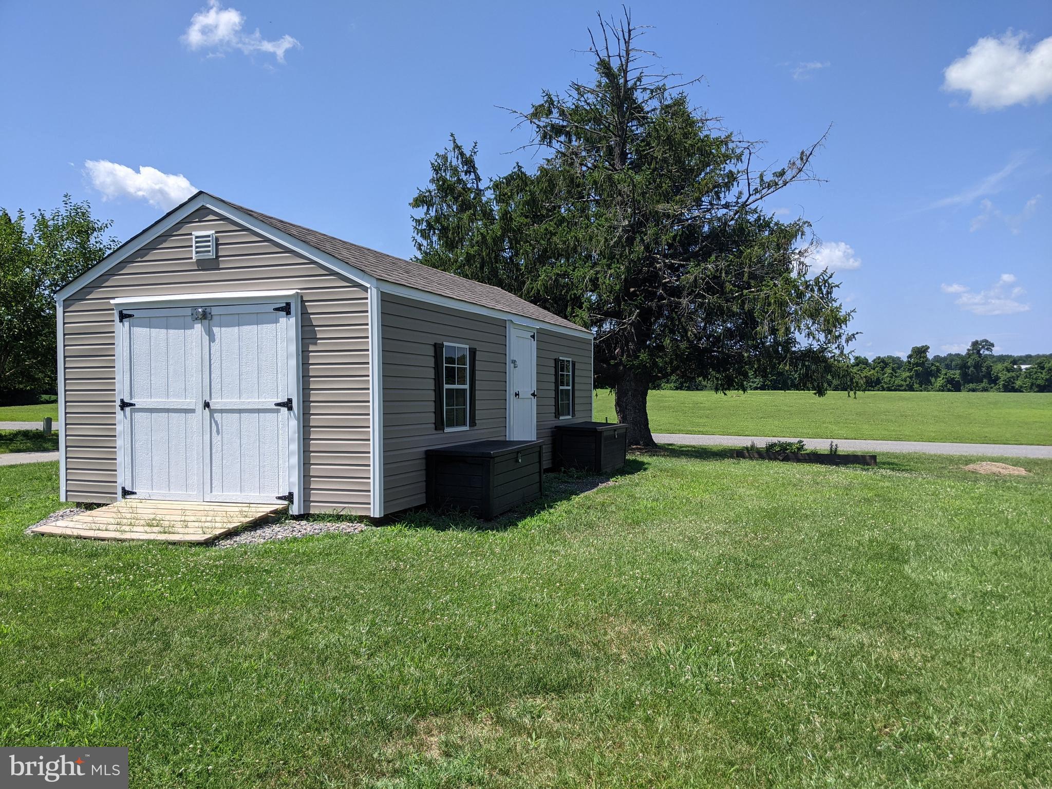6825 Briscoe Turn Road Owings, MD 20736 - Photo 46 of 47 a front view of a house with a yard and garage