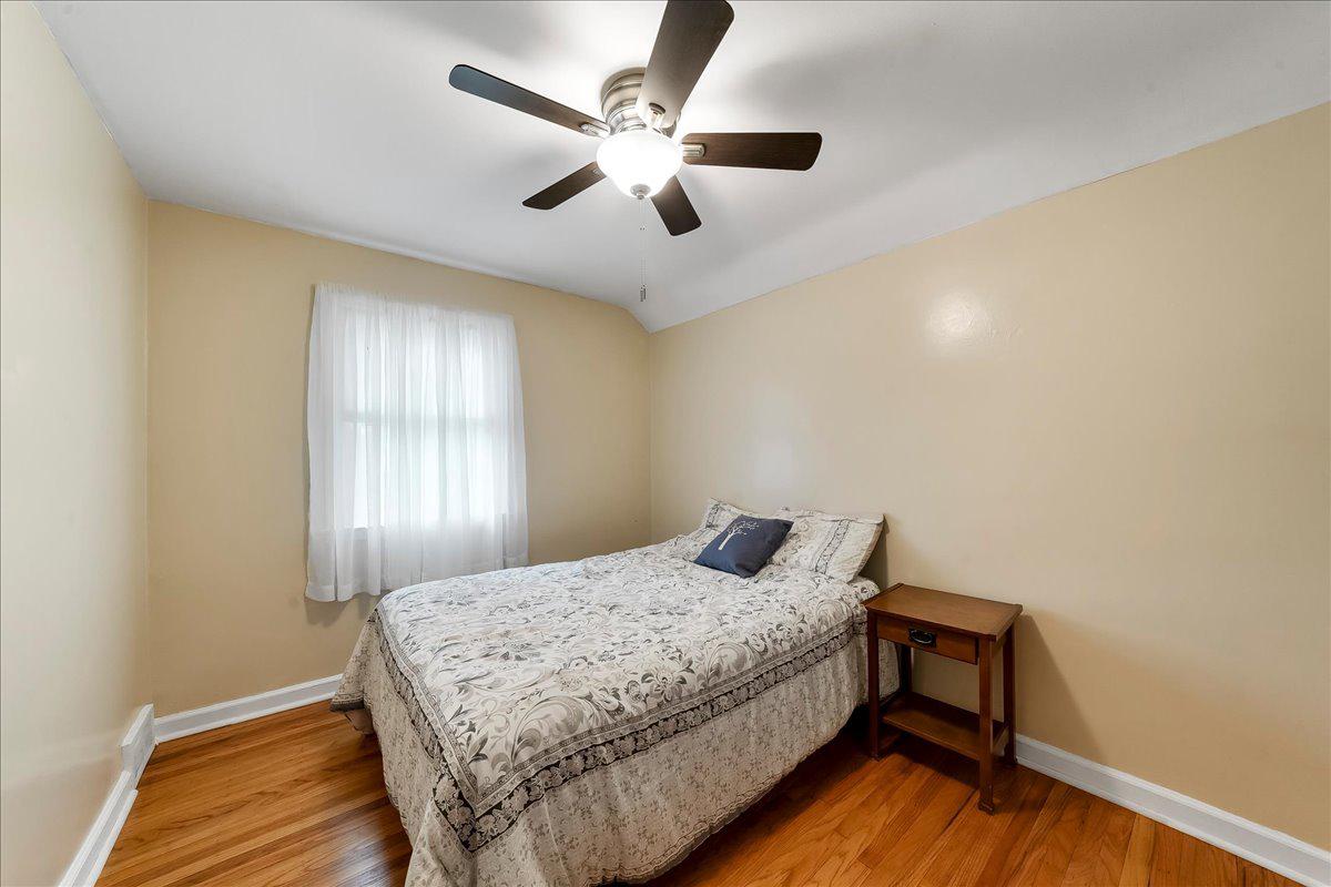 345 Holt Lane Springfield, PA 19064 - Photo 18 of 38 First bedroom with wood floors and ceiling fan