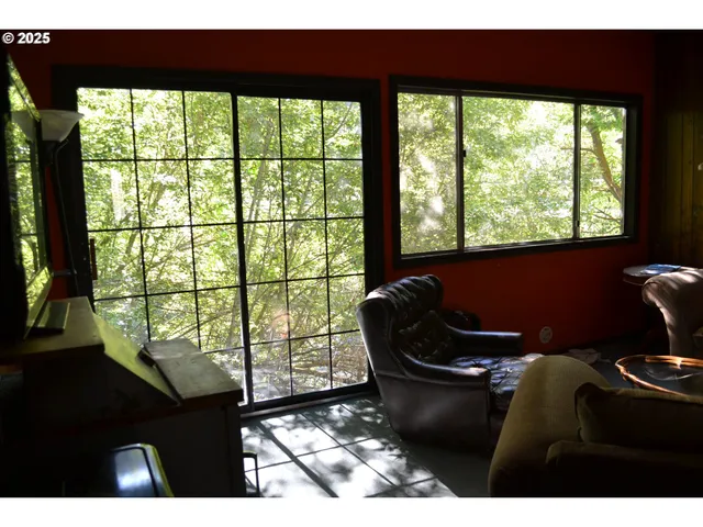 a living room with furniture and a floor to ceiling window