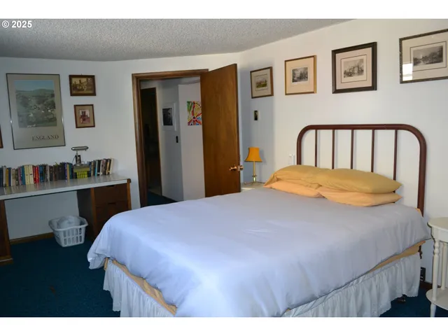 a bedroom with a bed and table