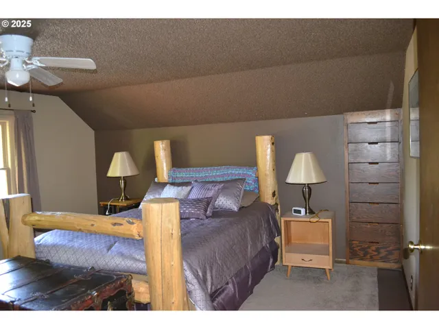 a bedroom with a bed and a lamp