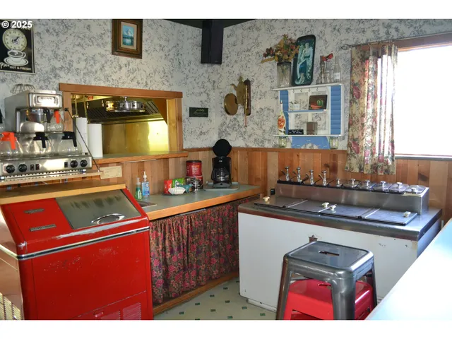 a kitchen with stainless steel appliances kitchen island granite countertop a sink stove and cabinets