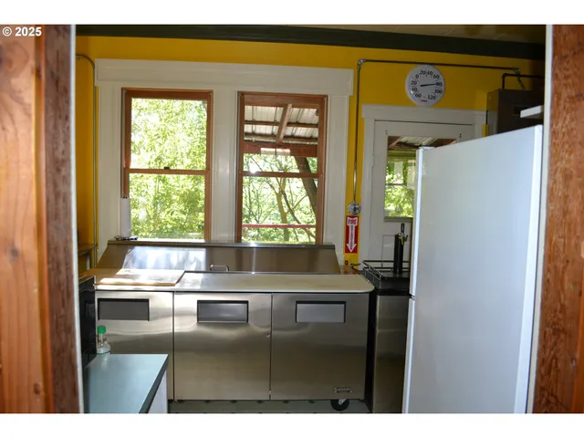 a kitchen with kitchen island a window a sink and a counter