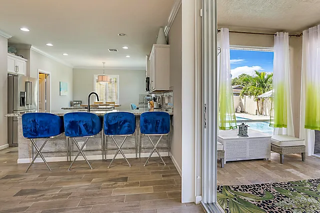 a metallic refrigerator freezer sitting inside of a kitchen