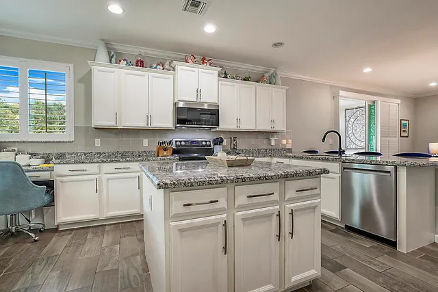 a kitchen with stainless steel appliances and cabinets