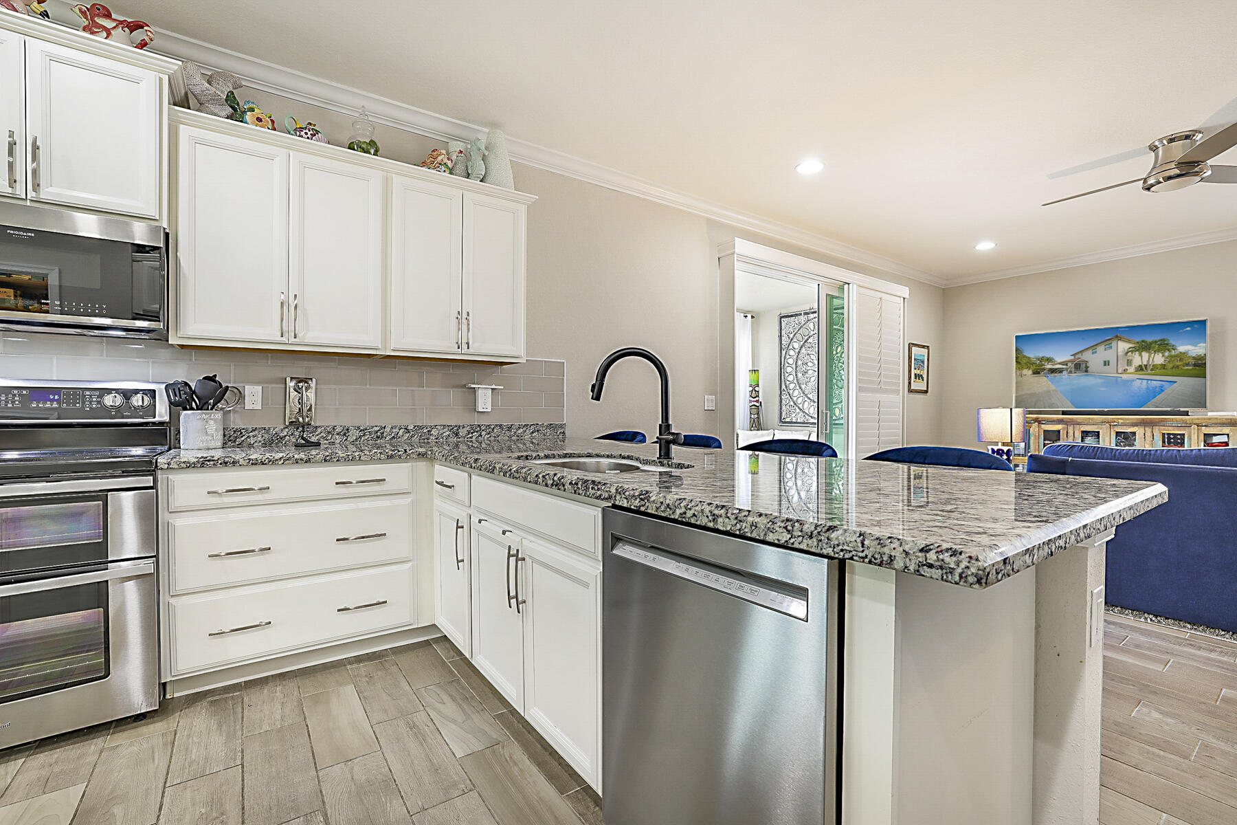 7131 Limestone Cay Road Limestone Creek, FL 33458 - Photo 18 of 65 a kitchen with stainless steel appliances granite countertop a sink stove and cabinets