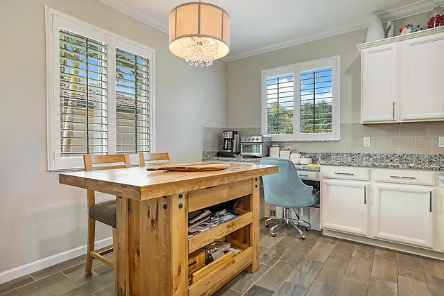a bedroom with a bed window and a ceiling fan
