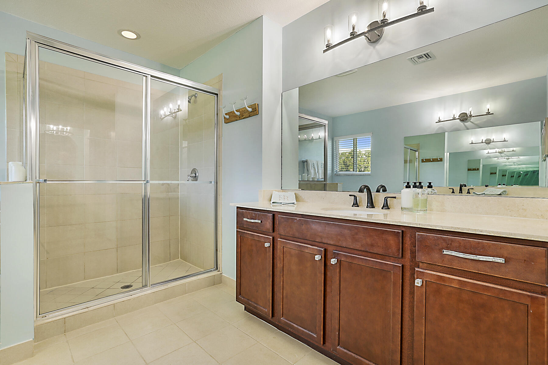 7131 Limestone Cay Road Limestone Creek, FL 33458 - Photo 29 of 65 a spacious bathroom with a shower sink and mirror
