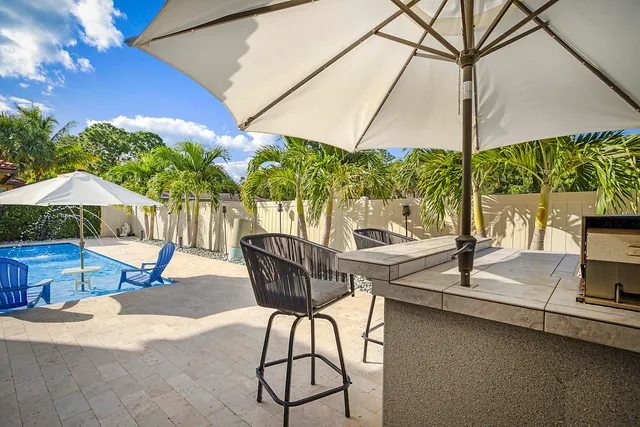 an aerial view of a house with garden space lake view and mountain view in back