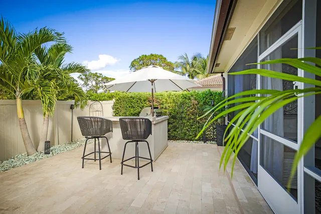 an aerial view of a house with a yard and potted plants