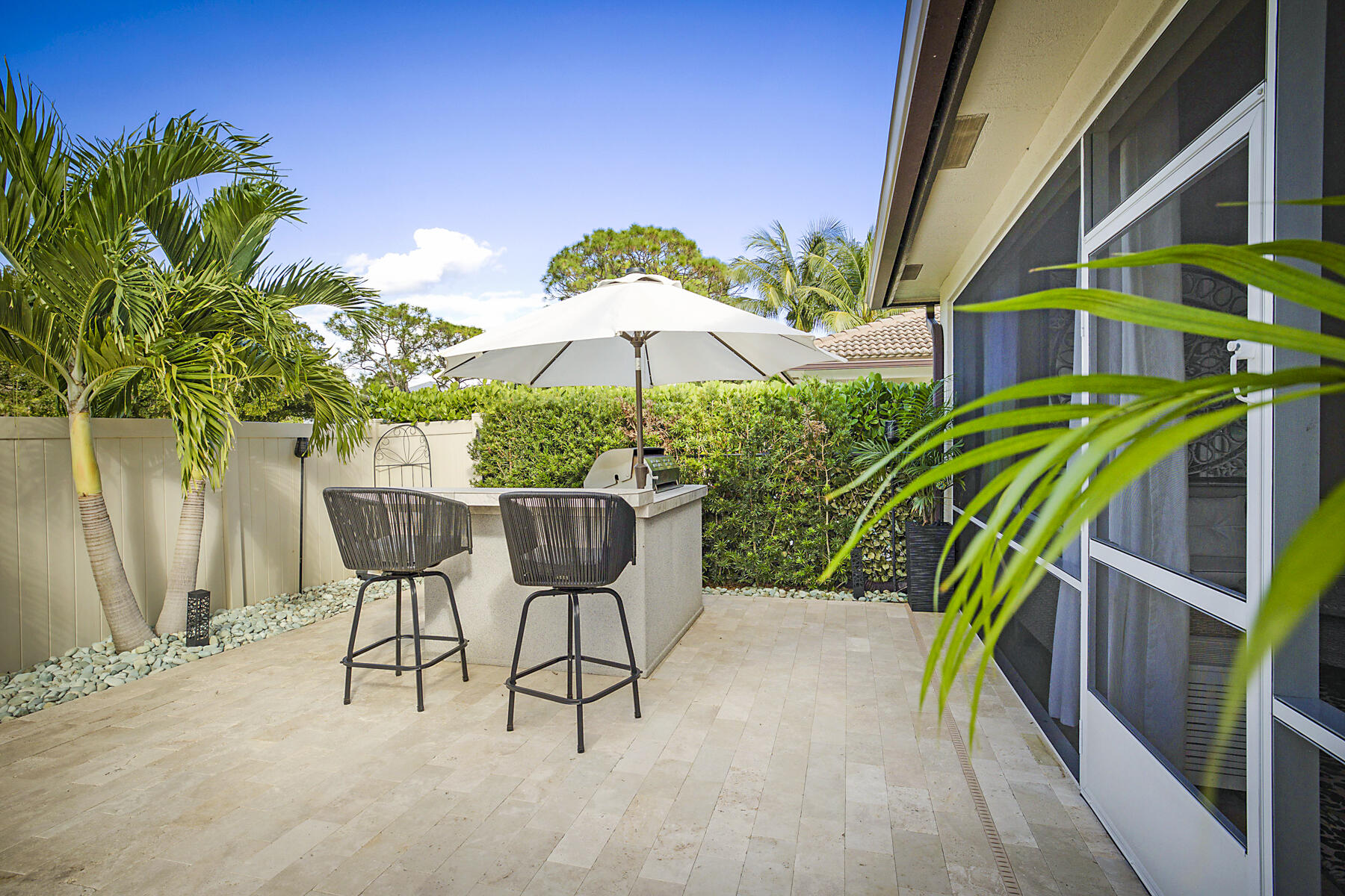 7131 Limestone Cay Road Limestone Creek, FL 33458 - Photo 50 of 65 a view of an chairs and table in the backyard