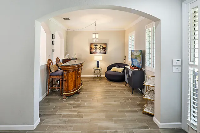 a view of a dining room with furniture and chandelier