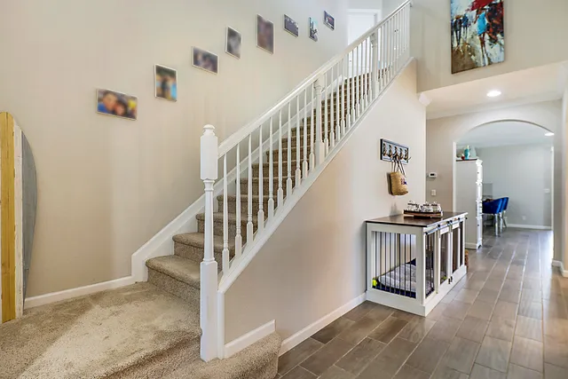 a kitchen with stainless steel appliances granite countertop a table chairs sink refrigerator and microwave