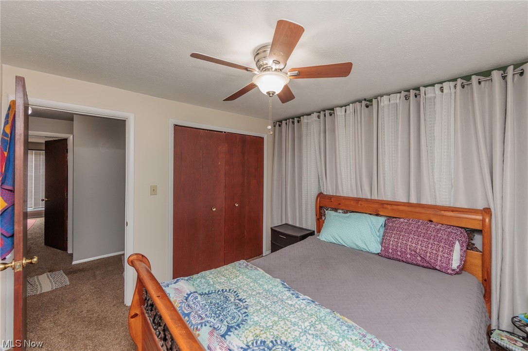 6476 State Road, Unit H8 Cleveland, OH 44134 - Photo 25 of 35 Carpeted bedroom with a textured ceiling and ceiling fan