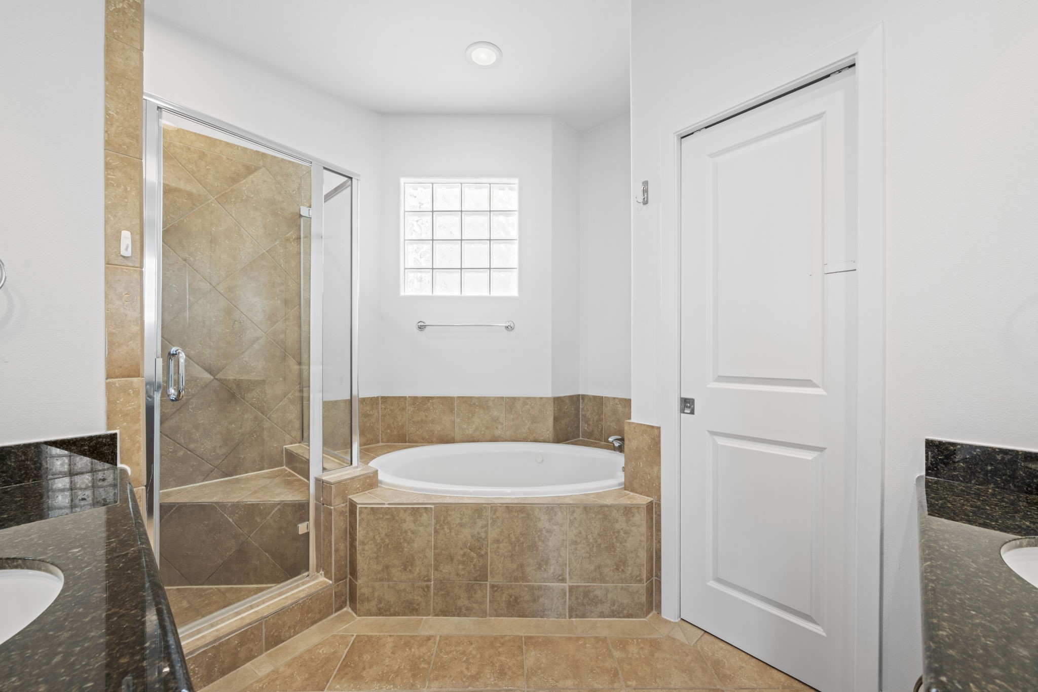 2413 Ralph Street, Unit 9 Houston, TX 77006 - Photo 15 of 19 Spa-inspired ensuite bath featuring dual vanities, a jetted tub, and a separate shower