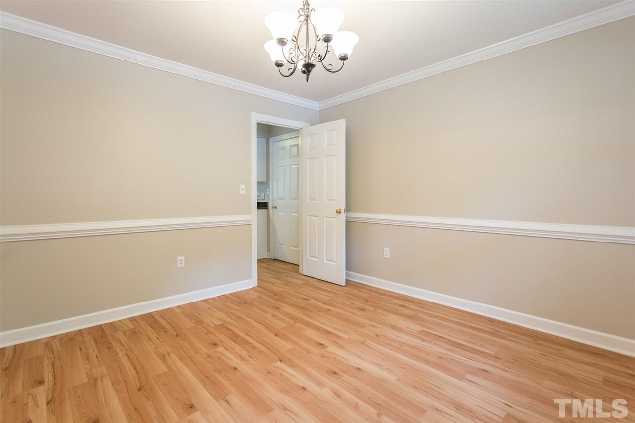 8805 Life Lane Raleigh, NC 27615 - Photo 7 of 28 Plantation shutters, chair railing and crown moulding