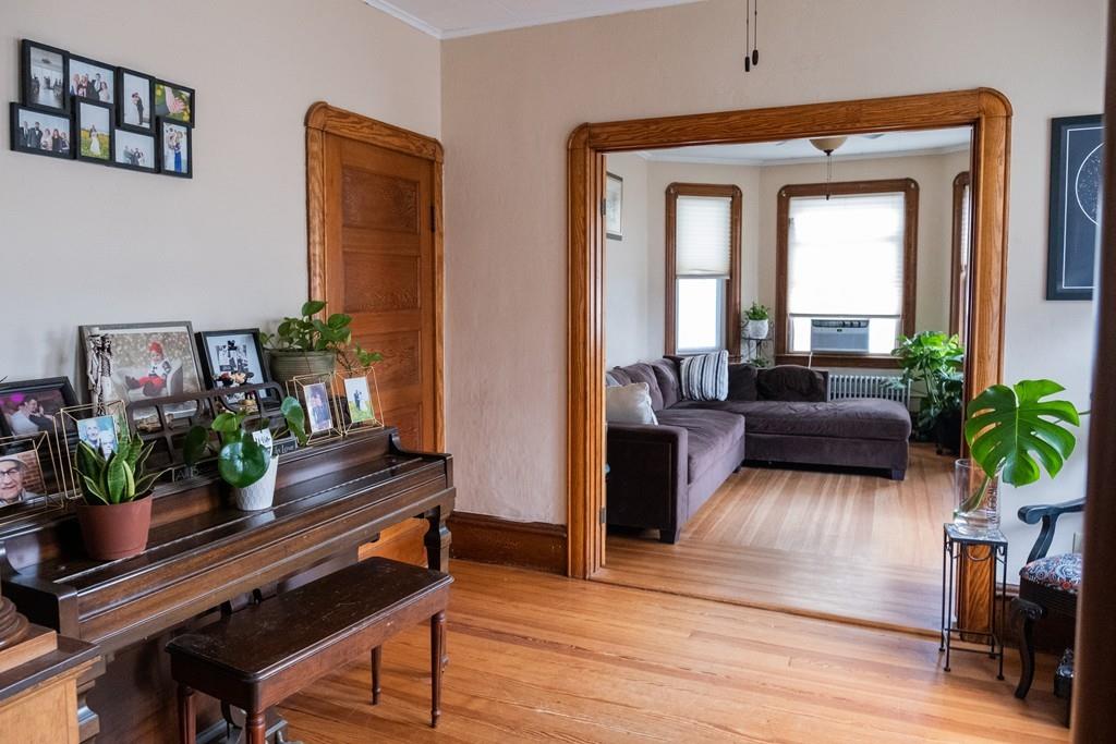 97 Stevens Street Fall River, MA 02721 - Photo 11 of 20 a living room with furniture and a potted plant