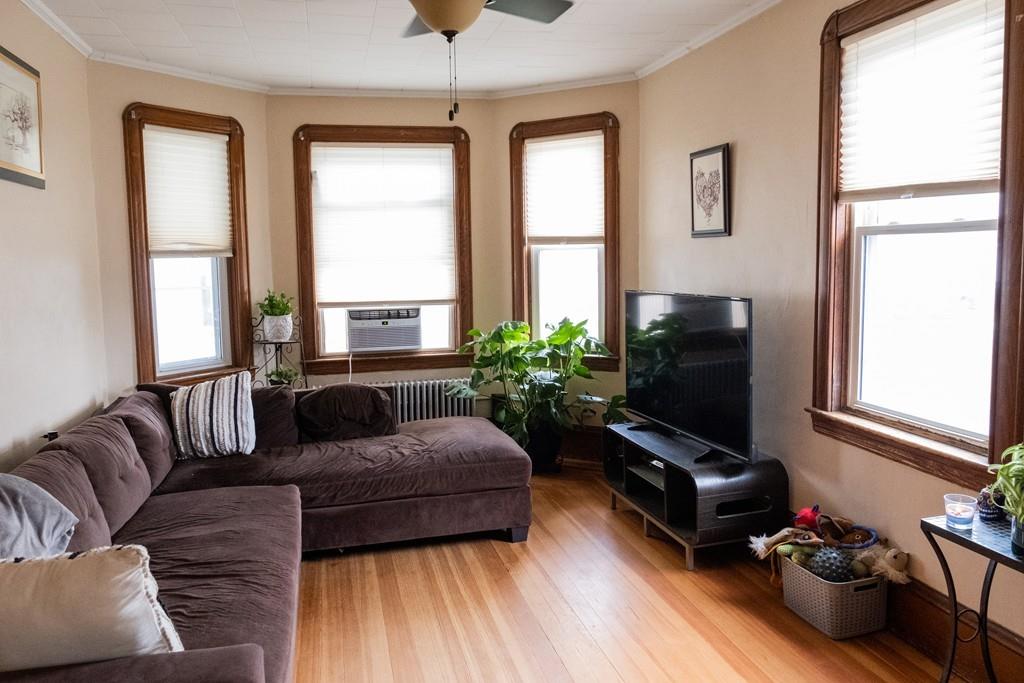 97 Stevens Street Fall River, MA 02721 - Photo 12 of 20 a living room with furniture fireplace and a flat screen tv