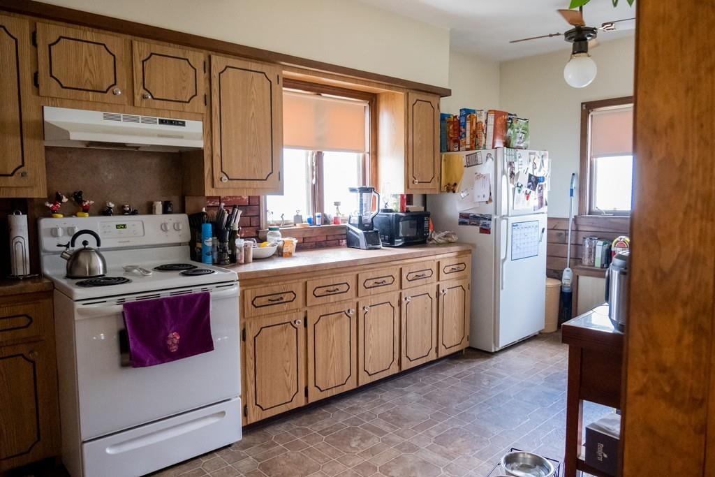 97 Stevens Street Fall River, MA 02721 - Photo 15 of 20 a open kitchen with cabinets a window and a sink