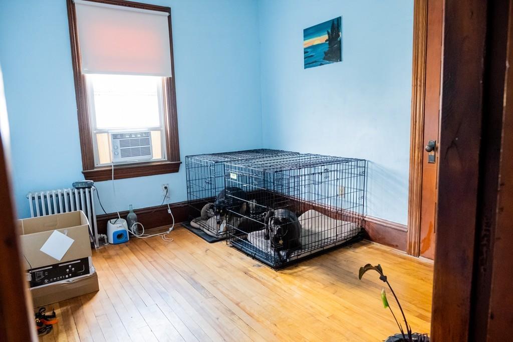 97 Stevens Street Fall River, MA 02721 - Photo 18 of 20 a bedroom with a bed and wooden floor