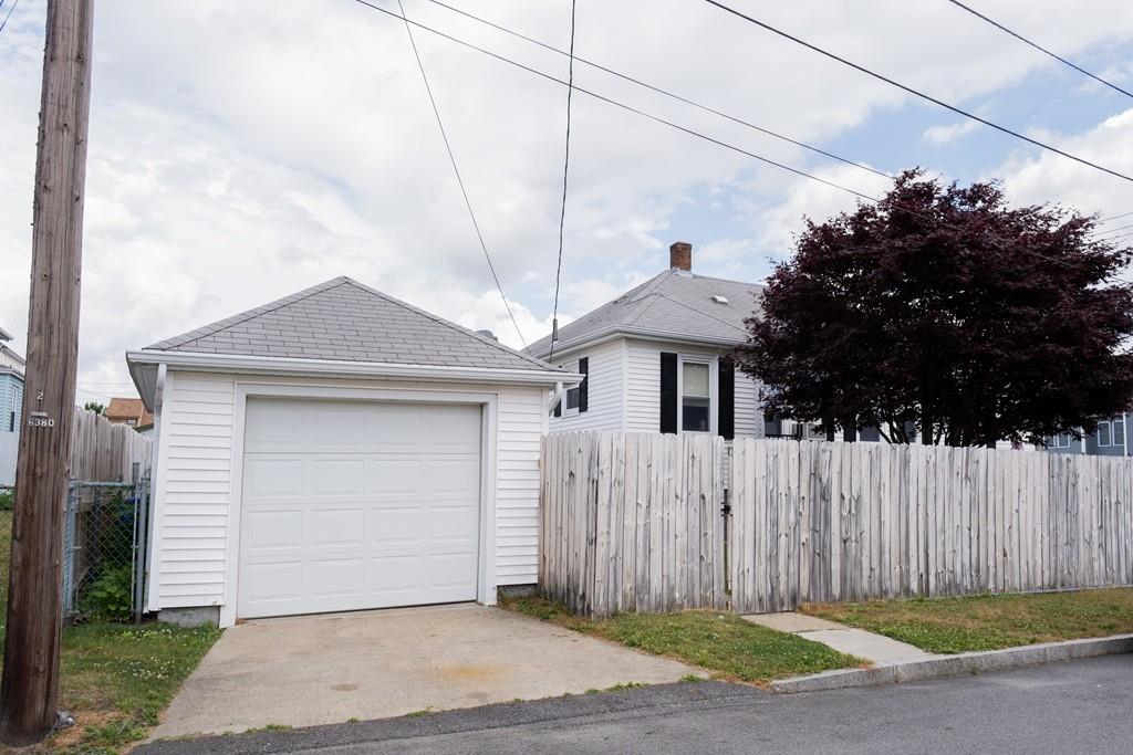 97 Stevens Street Fall River, MA 02721 - Photo 3 of 20 a front view of a house with a garden