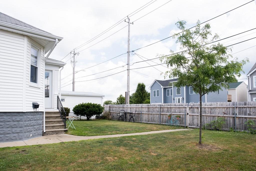 97 Stevens Street Fall River, MA 02721 - Photo 4 of 20 a view of a house with a small yard and wooden fence