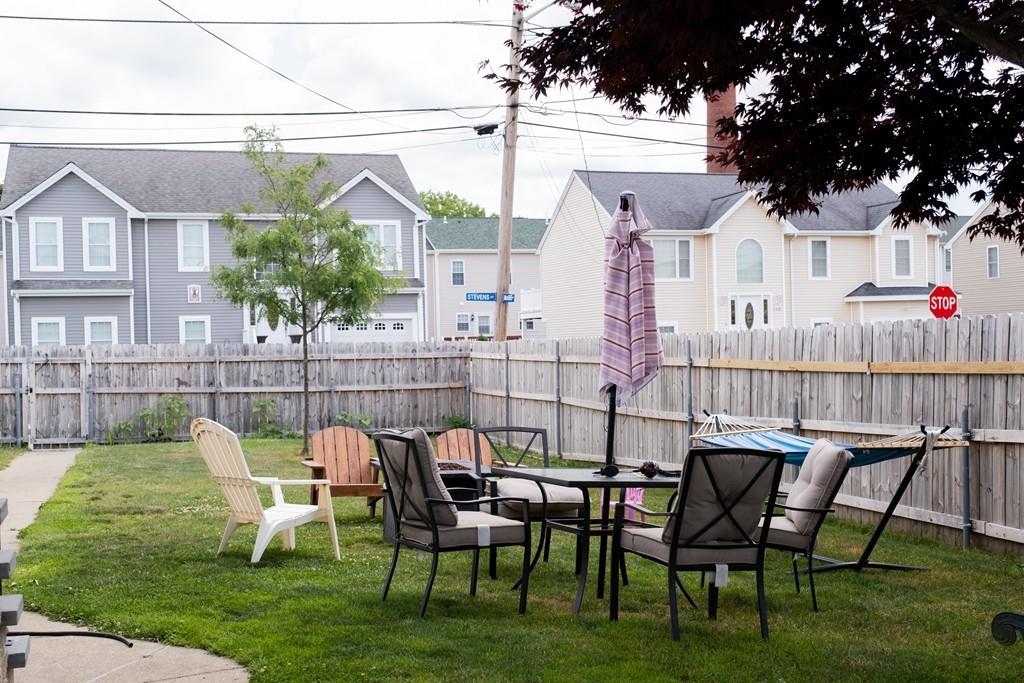 97 Stevens Street Fall River, MA 02721 - Photo 5 of 20 a view of a chair and table in backyard of the house