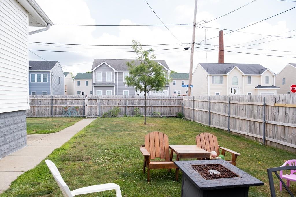 97 Stevens Street Fall River, MA 02721 - Photo 7 of 20 a view of a backyard with couches chair and wooden fence