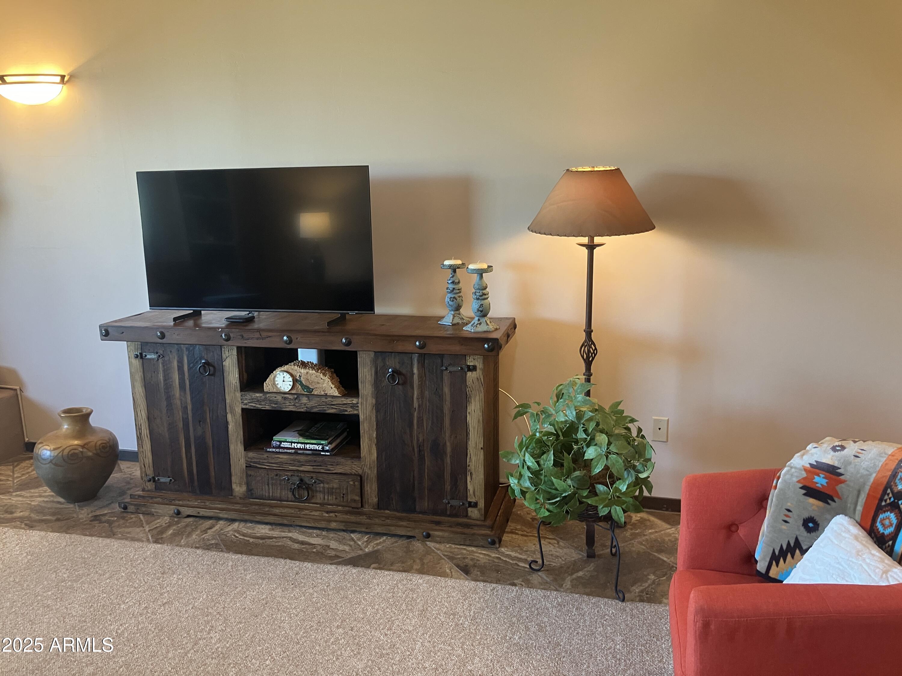 36601 North Mule Train Road, Unit 12C Carefree, AZ 85377 - Photo 11 of 42 a living room with furniture and a flat screen tv