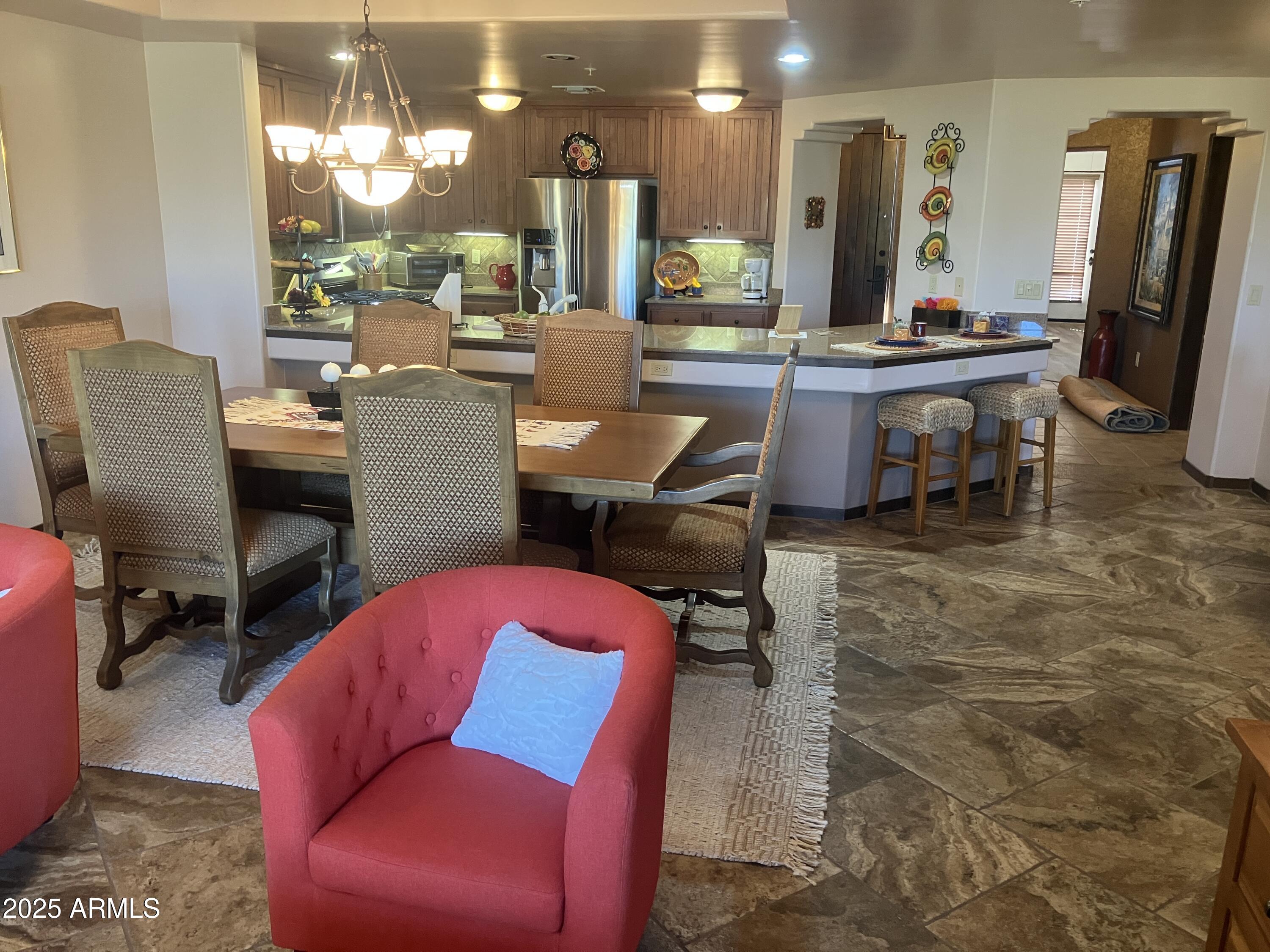 36601 North Mule Train Road, Unit 12C Carefree, AZ 85377 - Photo 12 of 42 a living room with furniture a large window and kitchen view