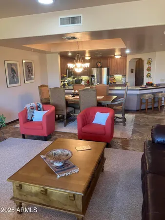 a living room with furniture and a pool table