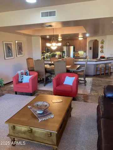 a living room with furniture and a pool table