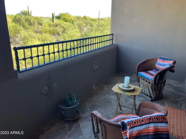 a view of a chairs and table in the balcony