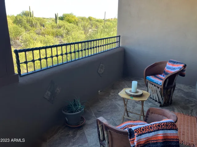 a view of a chairs and table in the balcony