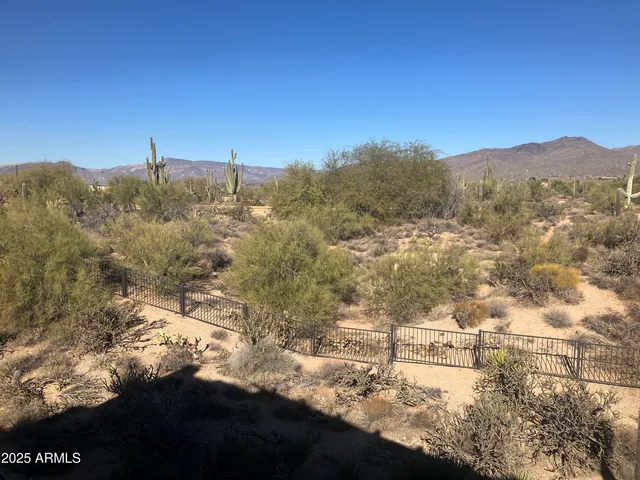 a large bed sitting in a bedroom next to a window