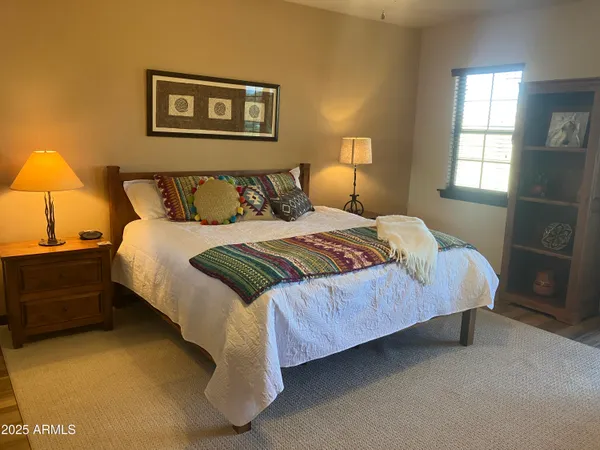 a bedroom with a bed and a television