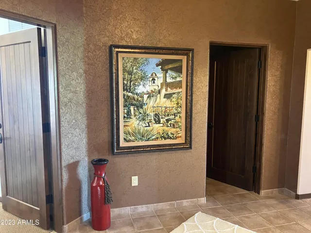 a view of a room that has a window and a refrigerator