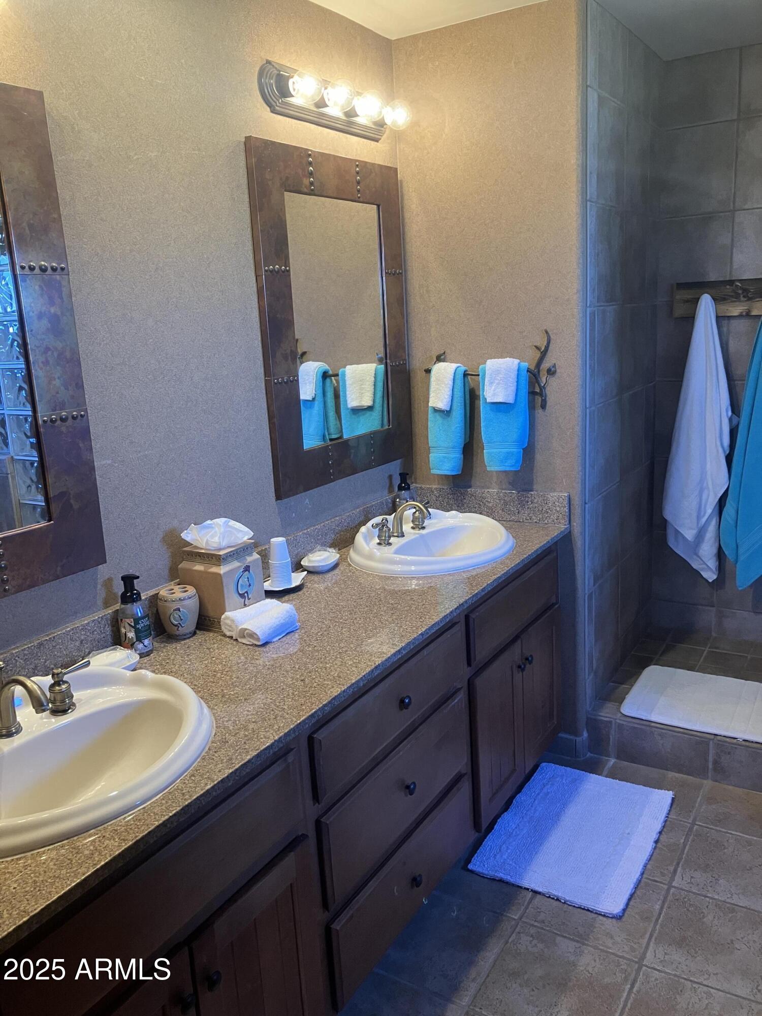 36601 North Mule Train Road, Unit 12C Carefree, AZ 85377 - Photo 22 of 42 a bathroom with a sink double vanity and a mirror