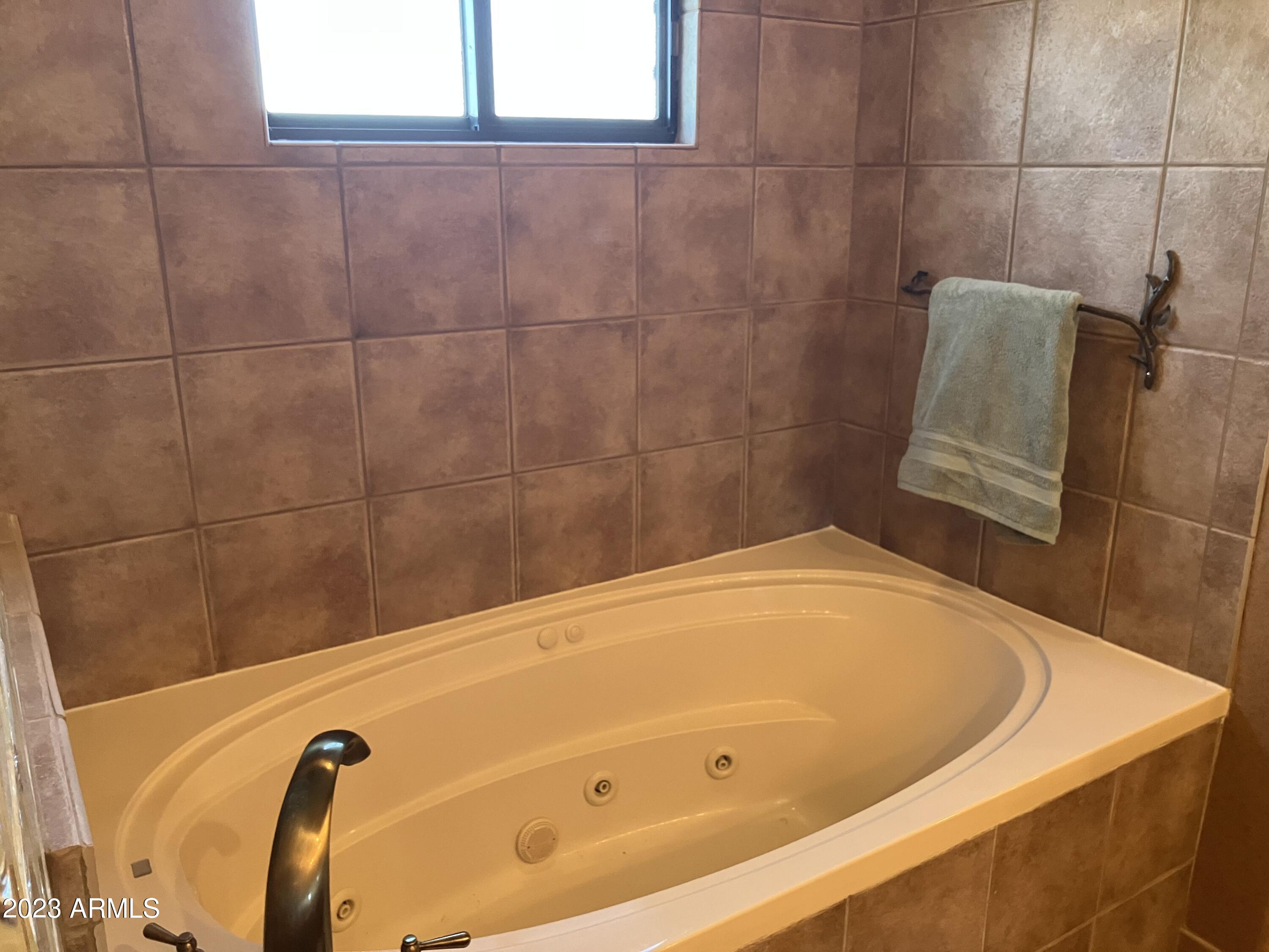 36601 North Mule Train Road, Unit 12C Carefree, AZ 85377 - Photo 24 of 42 a bathroom with a tub